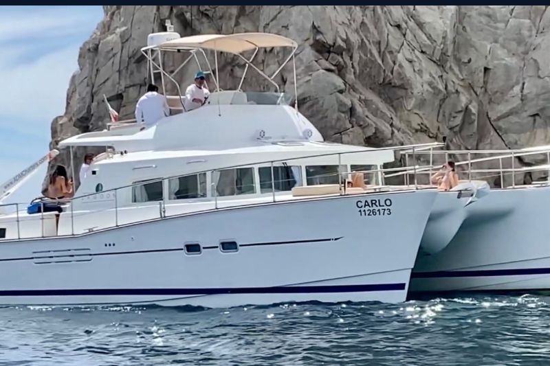 43-foot Lagoon power catamaran beneath the granite cliffs of Land's End